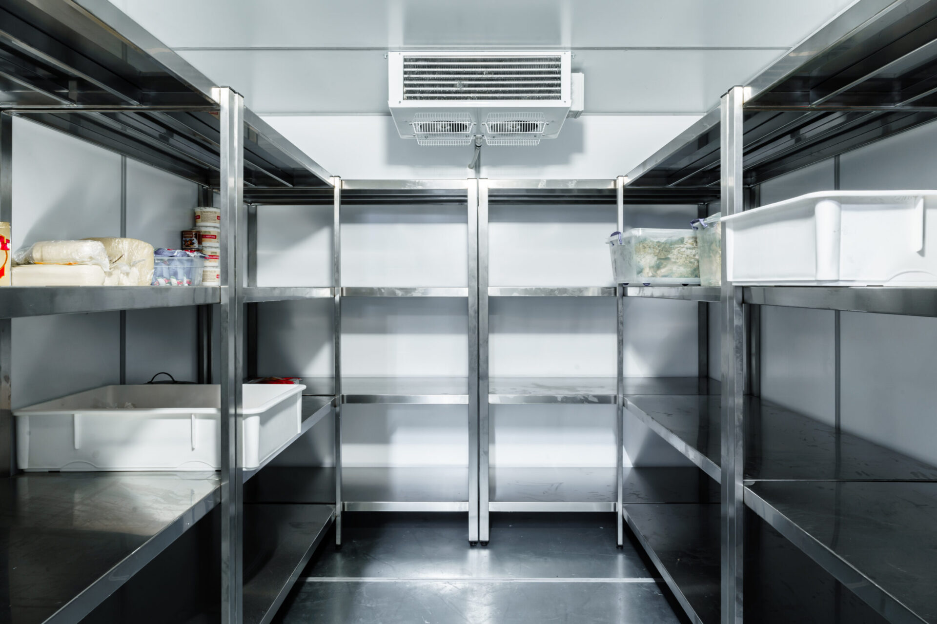 Refrigerator chamber with steel shelves in a restaurant close up